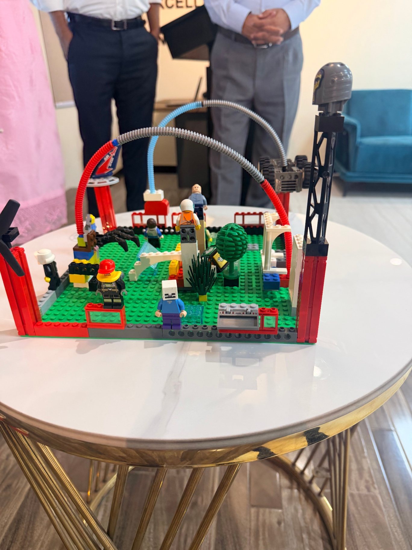 Close-up of a finished multi-coloured LEGO model built on a green baseplate during an AVA LEGO AdVentures workshop
