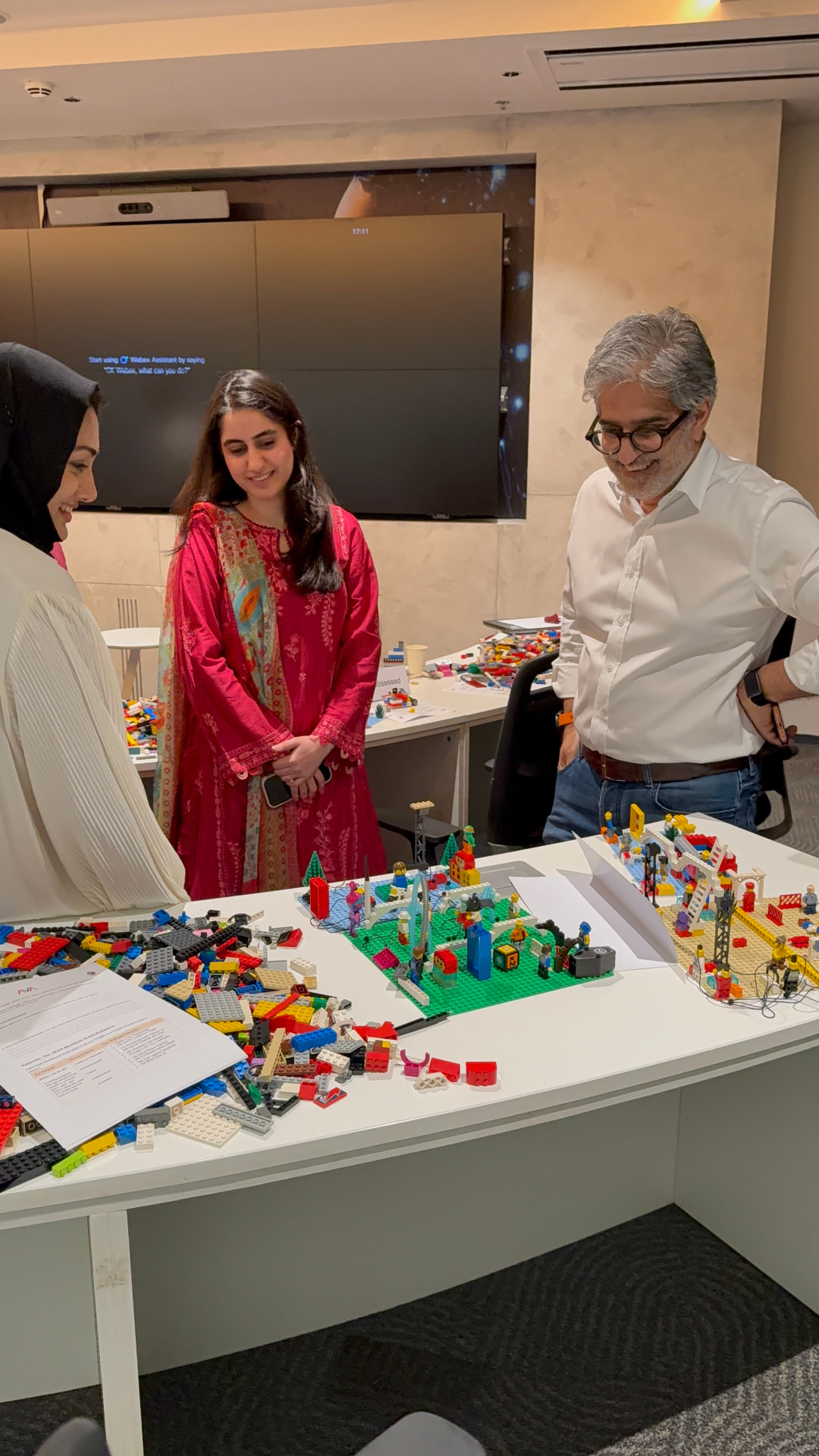 Pakistani leadership team building a shared strategy model with LEGO bricks during an AdVentures facilitation